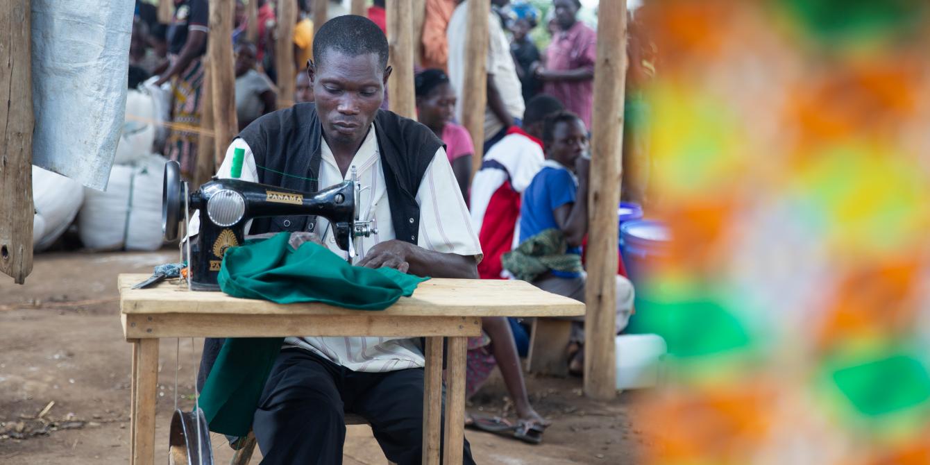 Emmanuel at his workstation. “This sewing machine helps me to support my family,” he says. photo credit:Viktorija Jeras / Oxfam